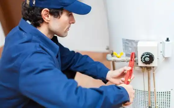 Technician fixing water heater